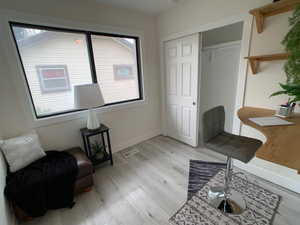 Living area featuring light wood-style flooring and baseboards