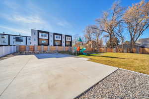 Fenced backyard with a playground and a residential view