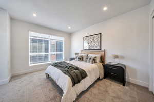Bedroom featuring light colored carpet and recessed lighting