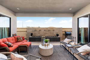 Fenced backyard featuring a patio area, an outdoor living space, and a grill