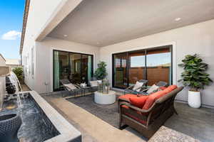 View of patio with an outdoor hangout area