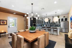 Dining space with recessed lighting, a chandelier, and light wood-style floors