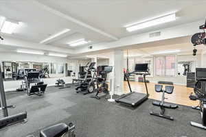 Exercise room featuring beamed ceiling