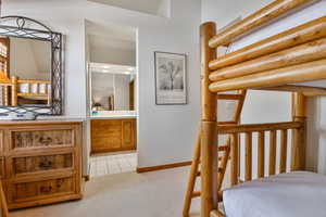 Bedroom with light carpet and light tile patterned floors