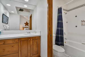 Ensuite bathroom featuring vanity and shower / bathtub combination with curtain