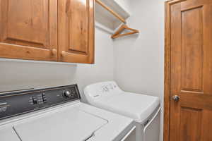 Laundry room featuring cabinet space and washer and dryer