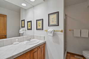 Bathroom featuring vanity, a shower stall, and tile patterned flooring