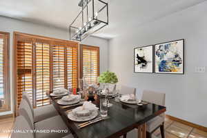 Dining room with light tile patterned flooring and baseboards