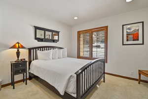 Bedroom featuring recessed lighting and light carpet