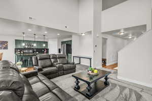 Living area with recessed lighting and light carpet