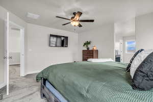 Carpeted bedroom featuring baseboards and a ceiling fan