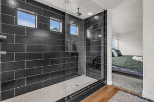 Bathroom featuring ensuite bath, wood finished floors, and a walk in shower