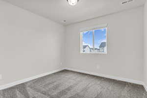 Unfurnished room with carpet flooring and baseboards