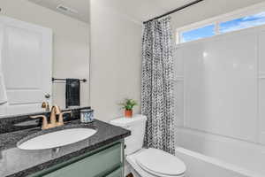 Bathroom featuring vanity and shower / tub combo