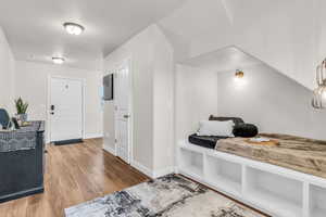 Foyer with light wood-style flooring and baseboards