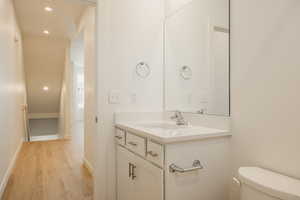 Bathroom featuring vanity, recessed lighting, and light wood-style floors