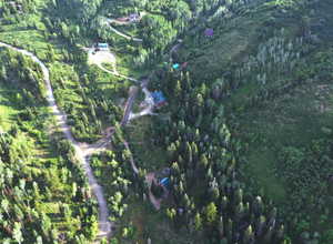 Aerial overview of property's location featuring a heavily wooded area