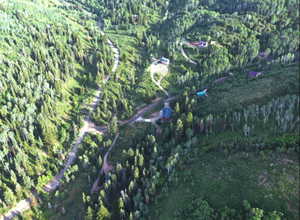 Aerial overview of property's location featuring a heavily wooded area