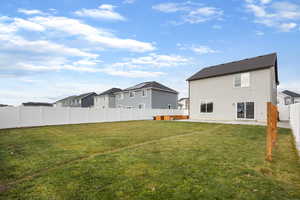 Back of property featuring a fenced backyard, stucco siding, a residential view, and a patio area