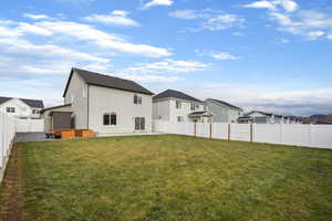 Back of house with a fenced backyard, a residential view, stucco siding, and a patio area