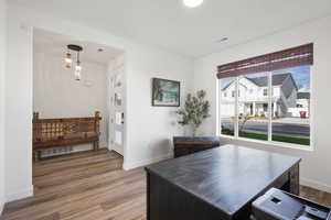 Dining room with dark wood finished floors and baseboards