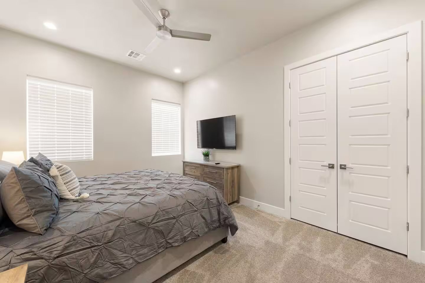 Bedroom featuring light colored carpet, a closet, ceiling fan, and recessed lighting