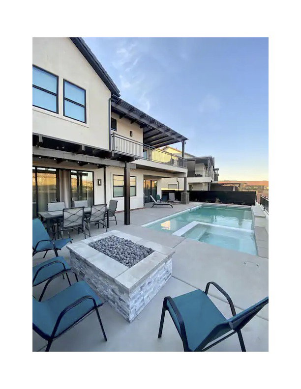 Outdoor pool with a fire pit, a balcony, and a patio