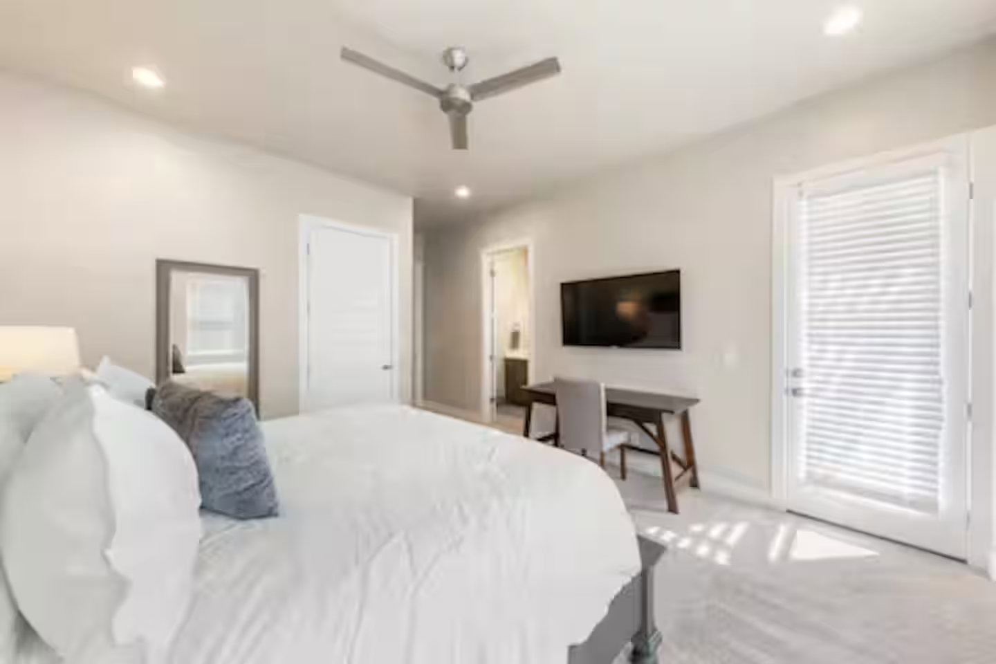 Bedroom featuring ceiling fan, recessed lighting, and ensuite bath