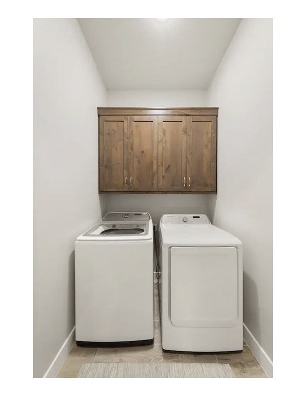 Laundry room with washing machine and dryer and cabinet space