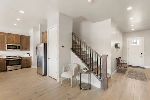 Foyer with recessed lighting, light wood-type flooring, and stairway
