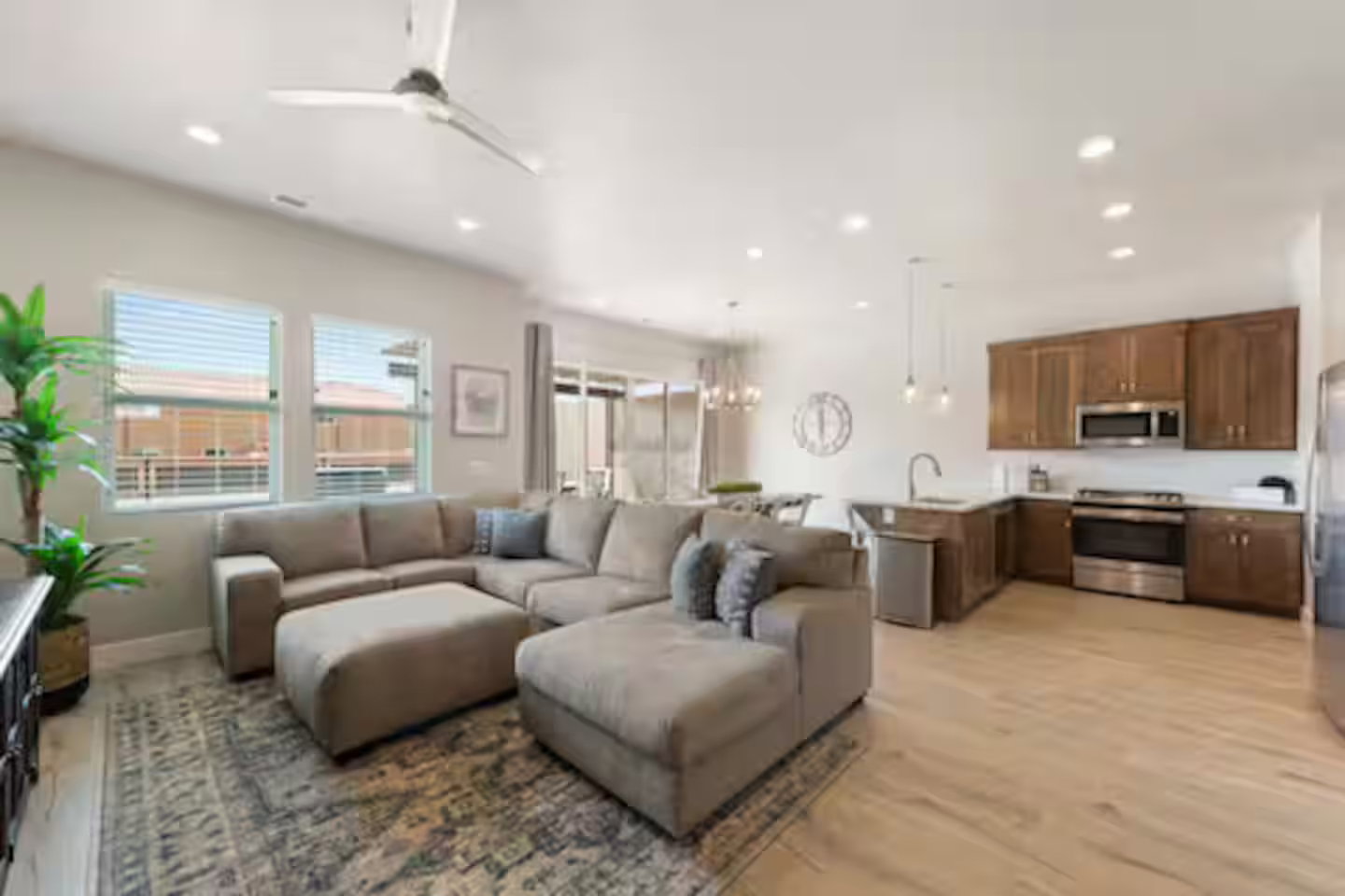 Living room with a chandelier, light wood-style flooring, recessed lighting, and ceiling fan