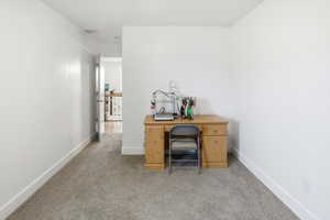 Office space or guest bedroom with carpet flooring and baseboards