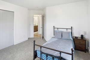 Bedroom with carpet flooring and baseboards