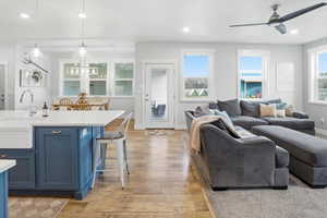 Living area featuring recessed lighting, ceiling fan, light wood-type flooring, and healthy amount of natural light