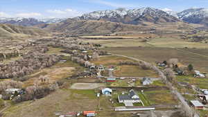 Aerial overview of property's location featuring a mountainous background and rural landscape