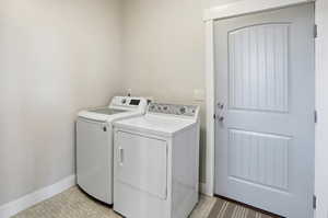ADU Laundry area featuring light flooring and washer and clothes dryer
