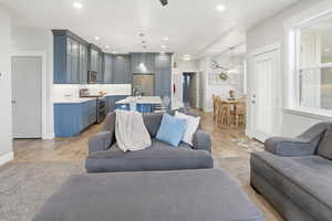Living room with light wood finished floors and recessed lighting