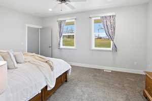 Main Floor Primary Bedroom with carpet floors, ceiling fan, and recessed lighting