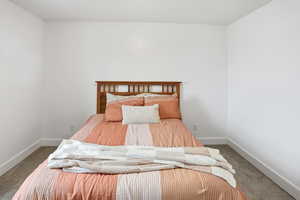 Carpeted bedroom featuring baseboards