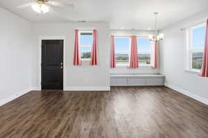 ADU Entryway featuring dark wood-type flooring, a chandelier, and ceiling fan