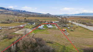 Overview of rural landscape featuring property boundaries highlighted and mountains