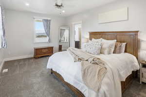 Primary Bedroom featuring carpet floors, ceiling fan, ensuite bath, and recessed lighting
