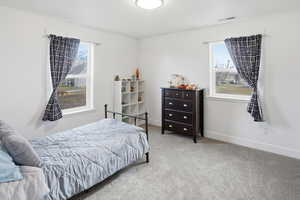 Bedroom featuring carpet and baseboards