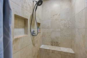 Full bathroom featuring a tile shower