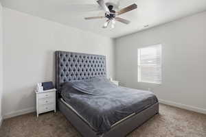 Carpeted bedroom with baseboards and ceiling fan