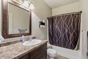 Bathroom with vanity and shower / tub combo