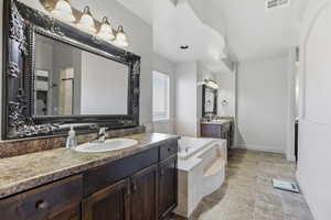 Bathroom with two vanities and a garden tub