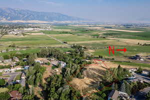 Aerial view of sparsely populated area with property parcel outlined and a mountain backdrop