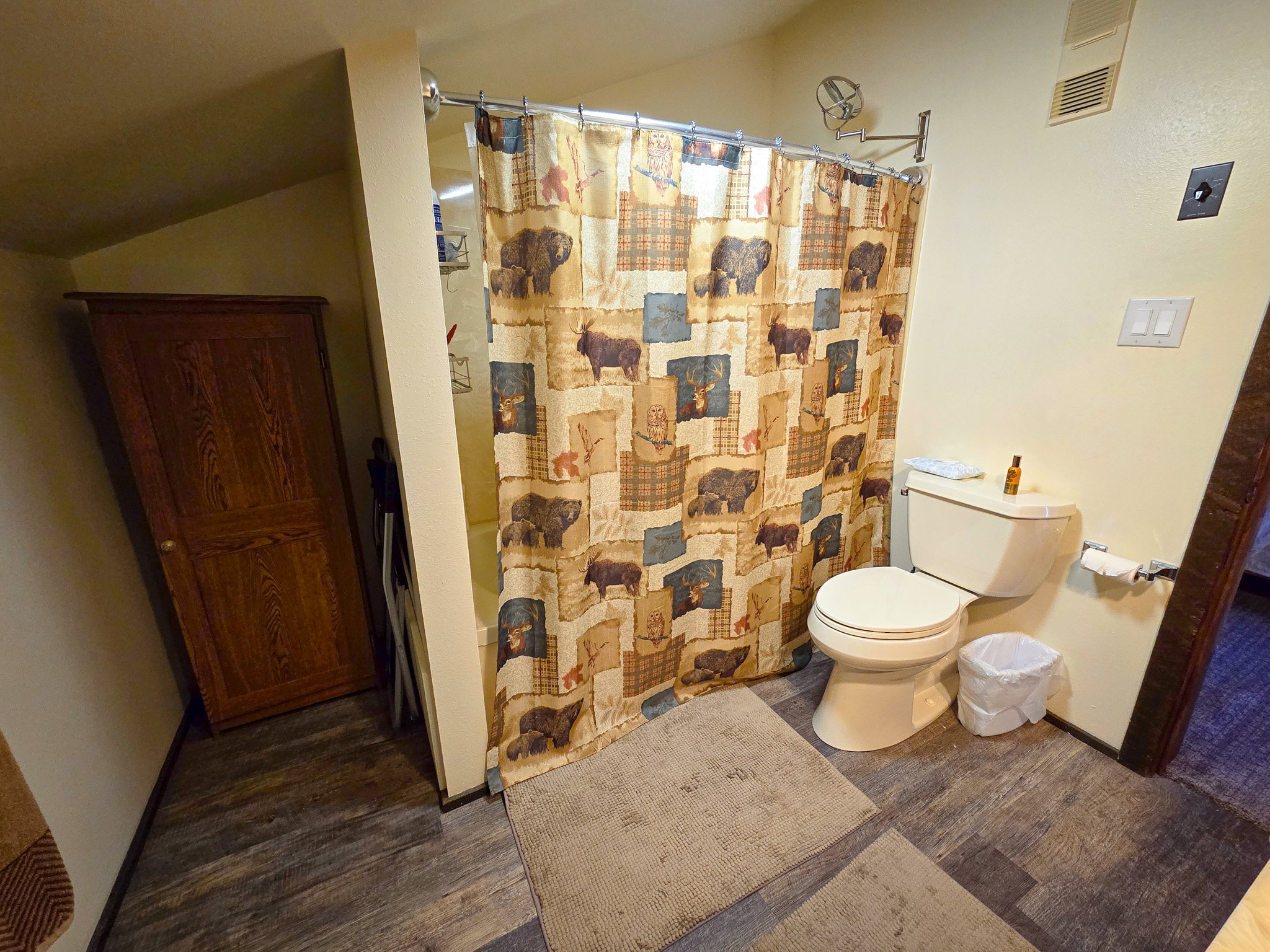 Full bathroom featuring dark wood-style floors and toilet