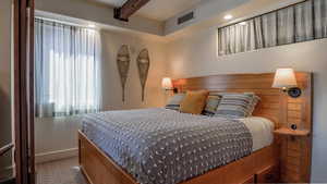 Bedroom featuring recessed lighting, beam ceiling, and carpet flooring